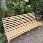 Large garden seat, wooden back, wrought iron frame.
